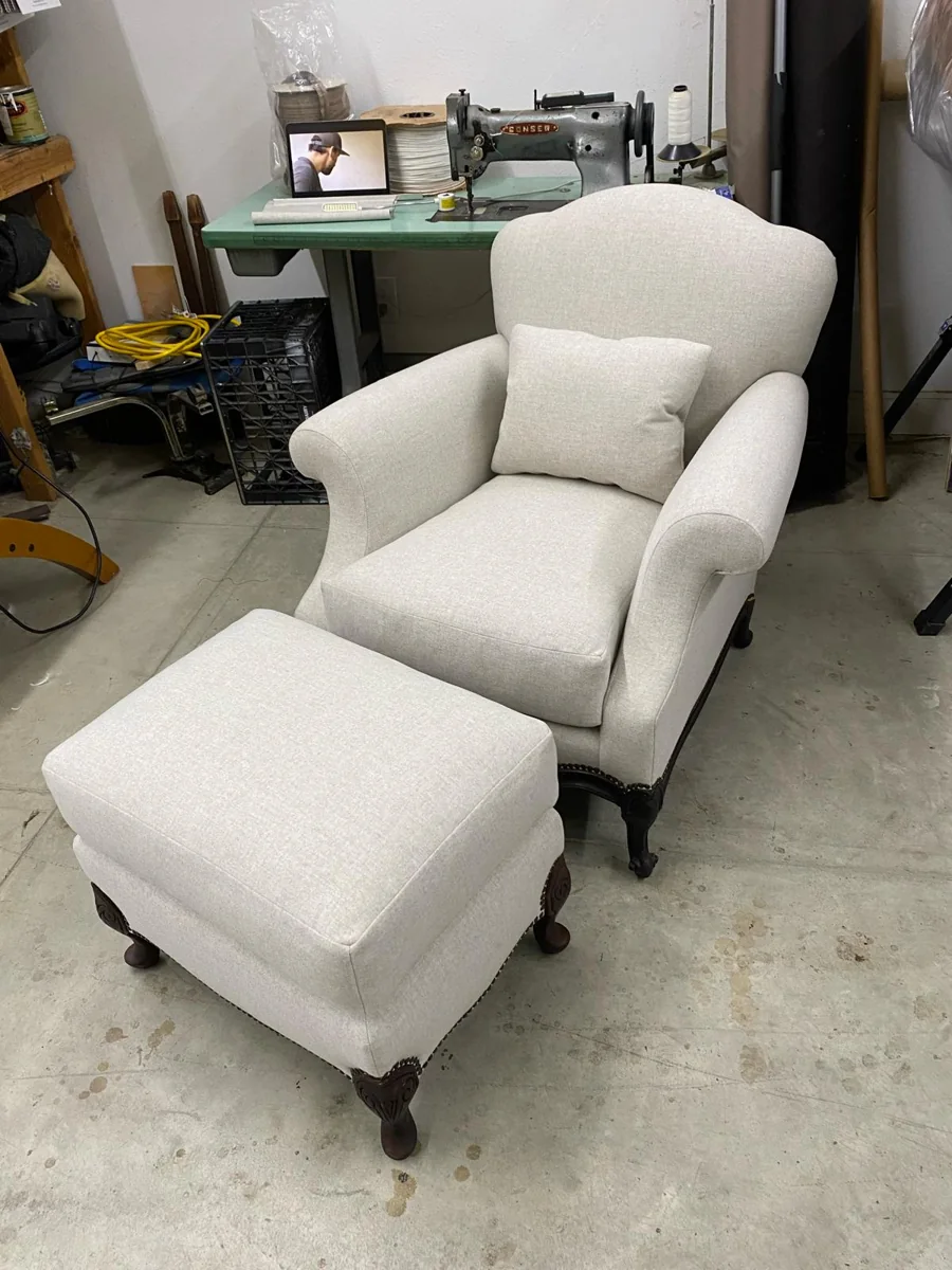 Cream upholstered armchair and matching ottoman in the Morales workshop