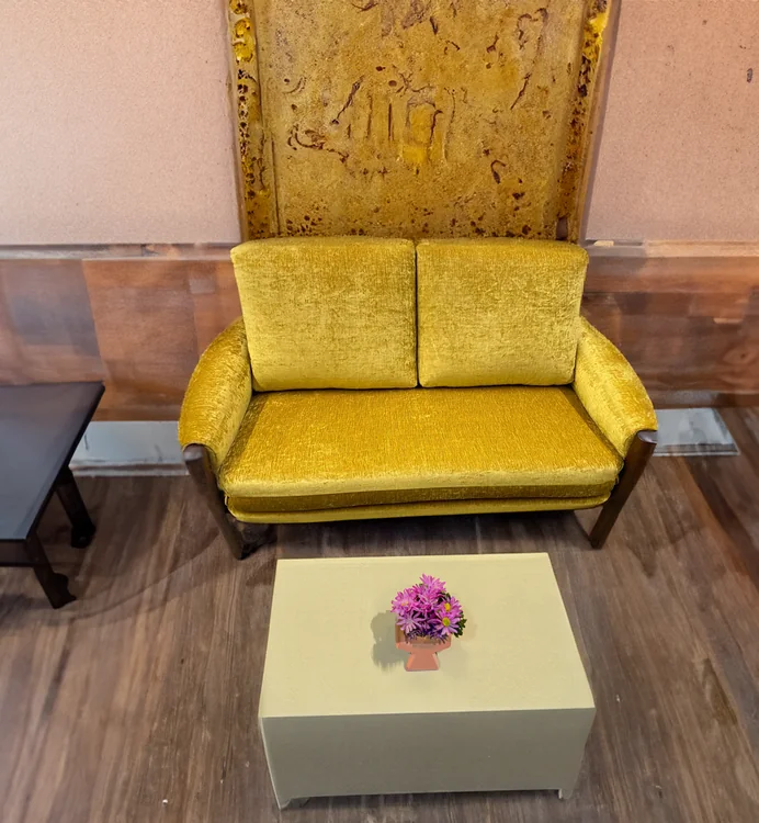 Finished golden-yellow loveseat with two back cushions and upholstered arms